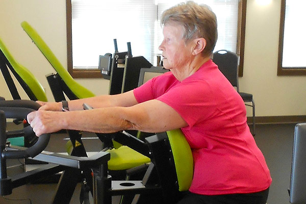 Resident exercising at The Springs on HUR equipment